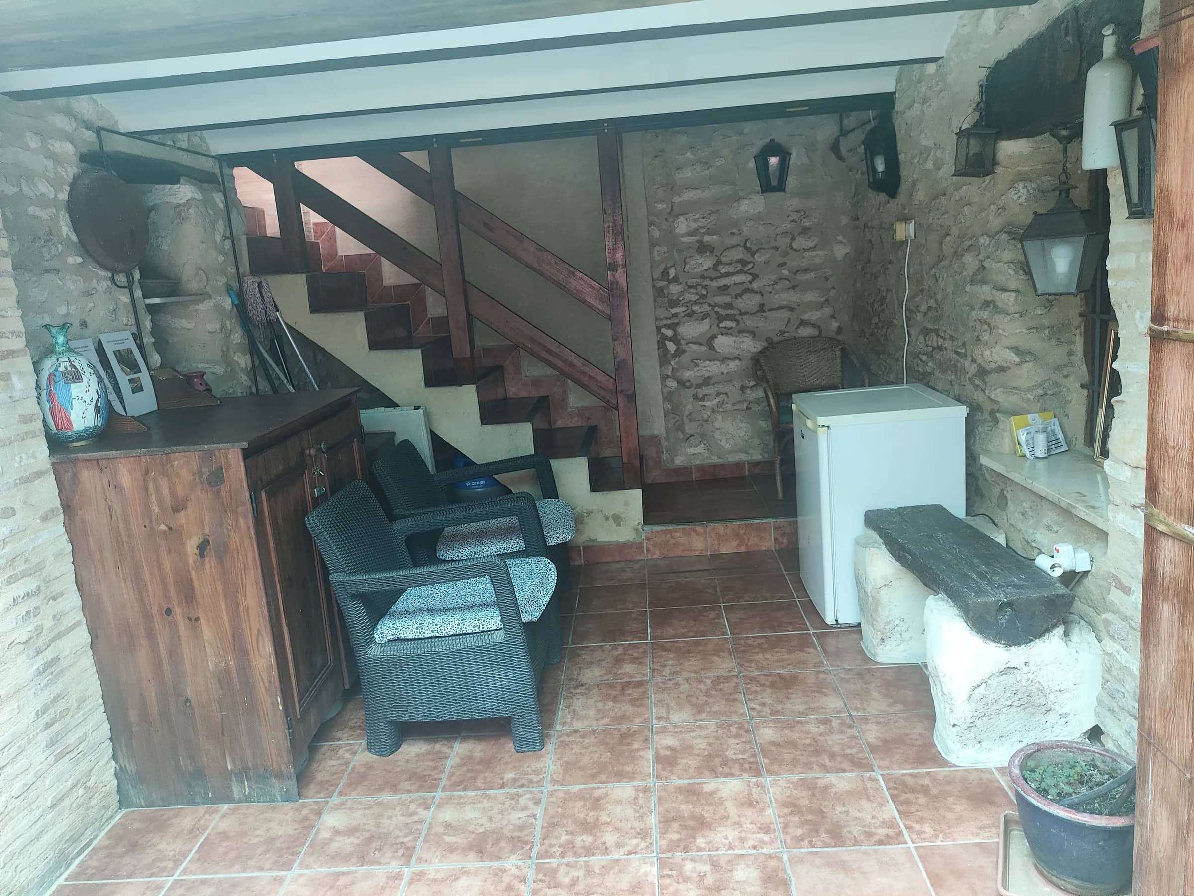 Escalera de piedra y sillones del patio interior, junto a los muros centenarios
